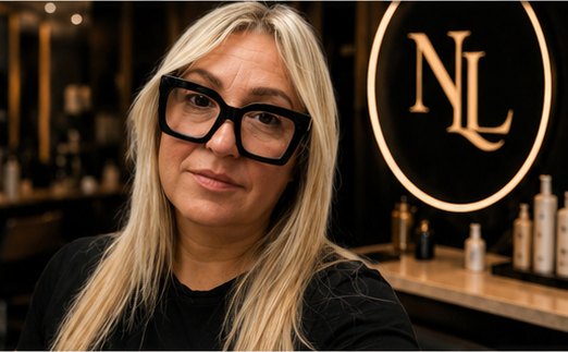 Stylist at New Look Hair Studio with NL neon logo